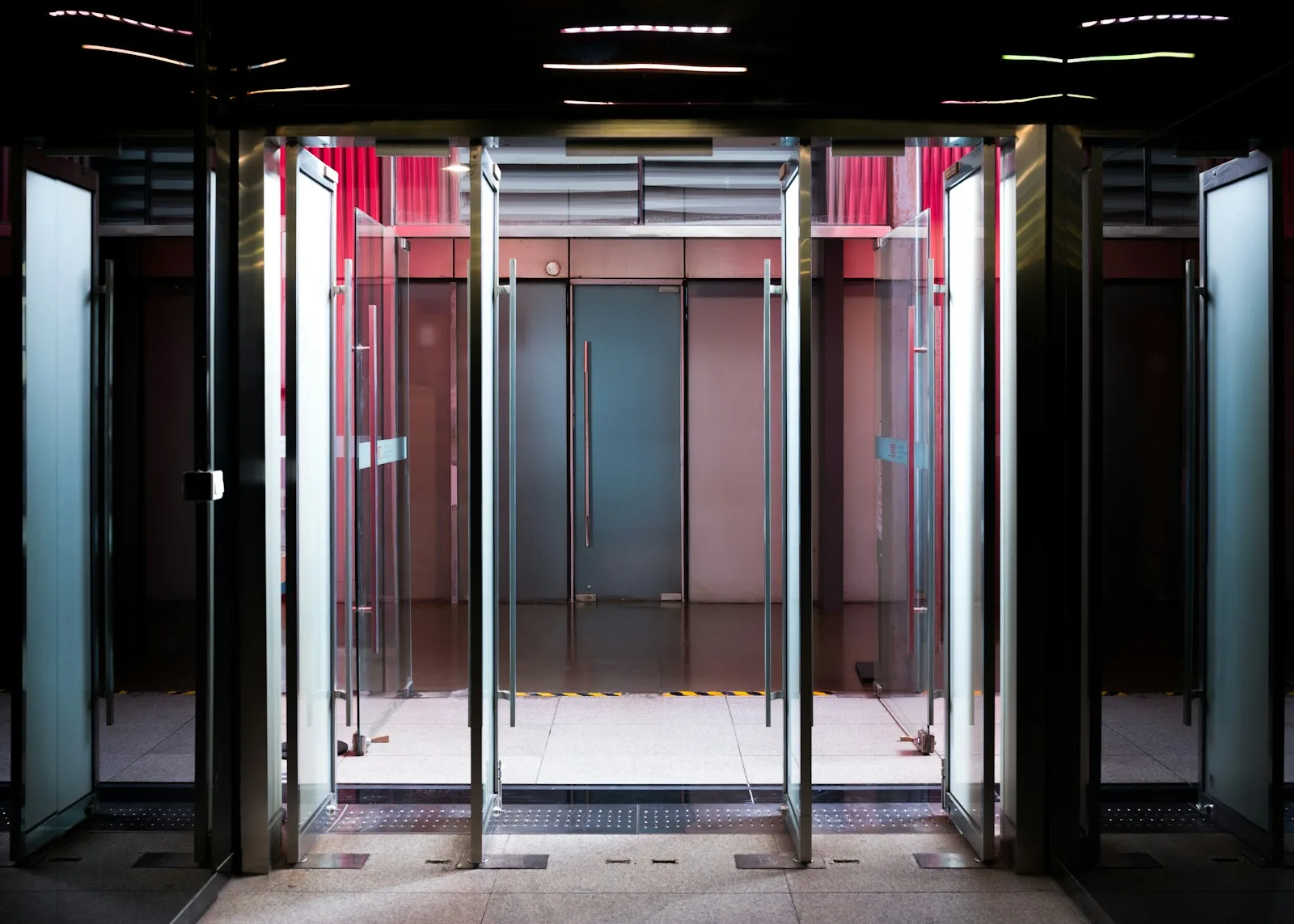 Glass revolving doors with modern interior lighting